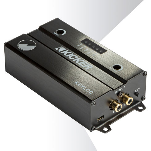 Angled view of KICKER KEYLOC line-out converter with brushed black housing and dual RCA output jacks.