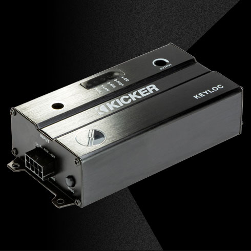 Angled view of KICKER KEYLOC line-out converter with brushed black housing and input connector.