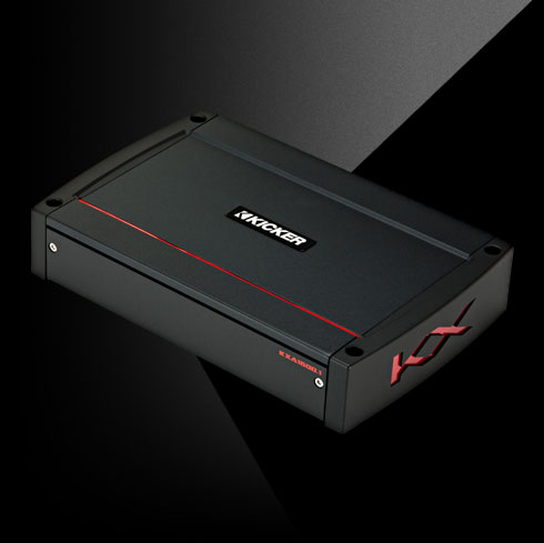 Angled view of KICKER KXA1600.1 amplifier with black housing, red accent line, and side KX logo.