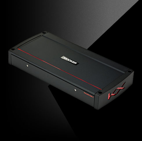 Angled view of KICKER KXA2400.1 amplifier with black housing, red accent line, and side KX logo.