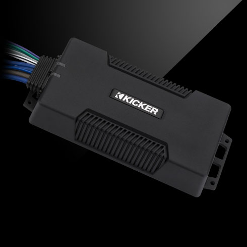 Angled view of KICKER PXA amplifier with rugged black housing and sealed wiring harness.