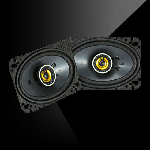 Pair of KICKER CS-Series 4x6-inch coaxial speakers with yellow accents.