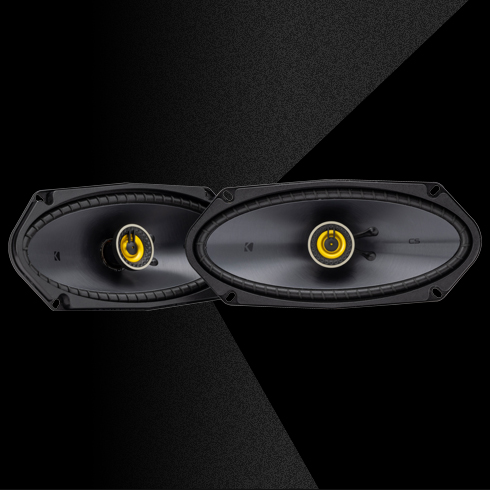 KICKER CS-Series CSC410 4x10-inch coaxial speakers with yellow dome tweeters.