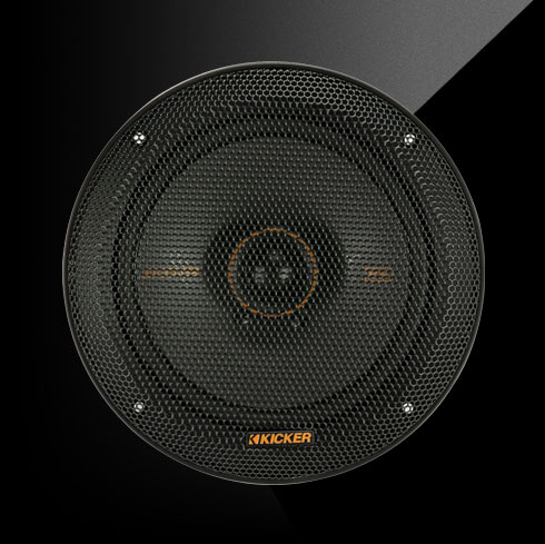Close-up of a KICKER KS-Series 6.5-inch coaxial car speaker with a black grille and orange accent ring.