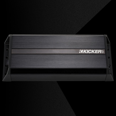 Top view of rugged KICKER PX amplifier with black aluminum casing and side mounting brackets.