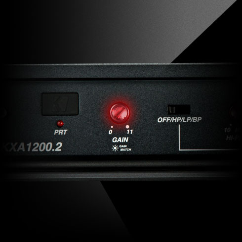 Close-up of illuminated red gain control knob on KICKER KXA1200.2 amplifier with labeled settings.