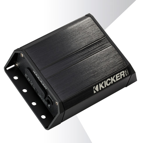 Angled view of compact KICKER PX amplifier with brushed black aluminum housing and side mounting bracket.