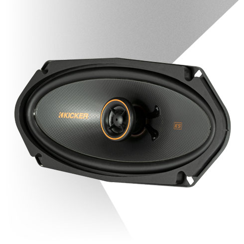KICKER KS-Series 6x9-inch coaxial speaker with black cone, orange trim tweeter, and low-profile design.