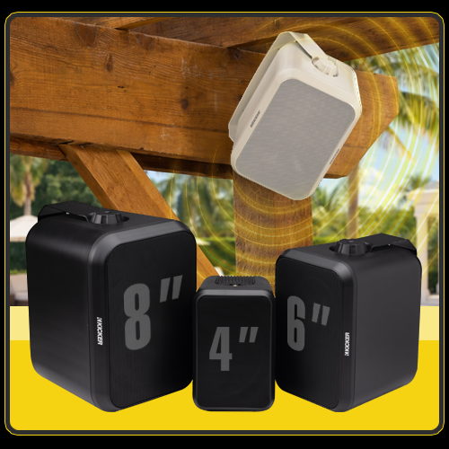 KICKER OA Series outdoor speakers mounted and displayed near a wooden patio structure, including white and black speakers in 4-inch, 6-inch, and 8-inch sizes.