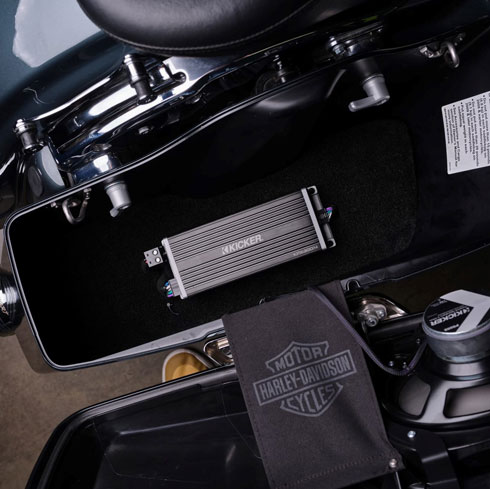 KICKER KPX amplifier installed inside a Harley-Davidson motorcycle saddlebag.